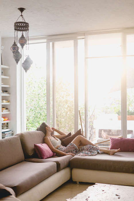 picture of a woman on a sofa gazing out the window wondering how to fix PCOS related infertility