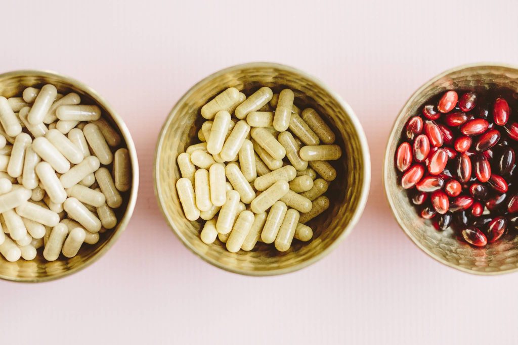 picture of three bowls with capsules for natural treatment of PCOS by a naturopathic doctor