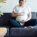 picture of a pregnant woman on a couch who knows about getting pregnant with PCOS
