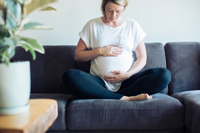 picture of a pregnant woman on a couch who knows about getting pregnant with PCOS