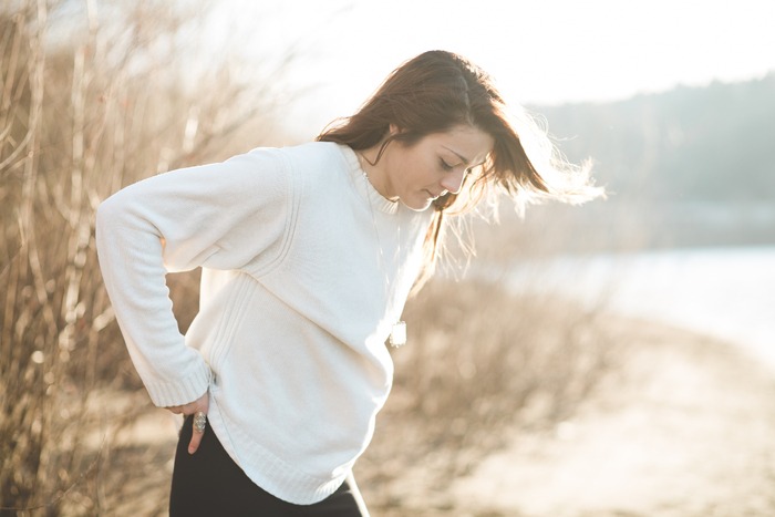picture of woman in a field wondering why pcos causes hair loss