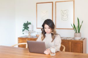picture of a woman at a desk working on a laptop research which pcos lab tests she should do with a Toronto naturopath